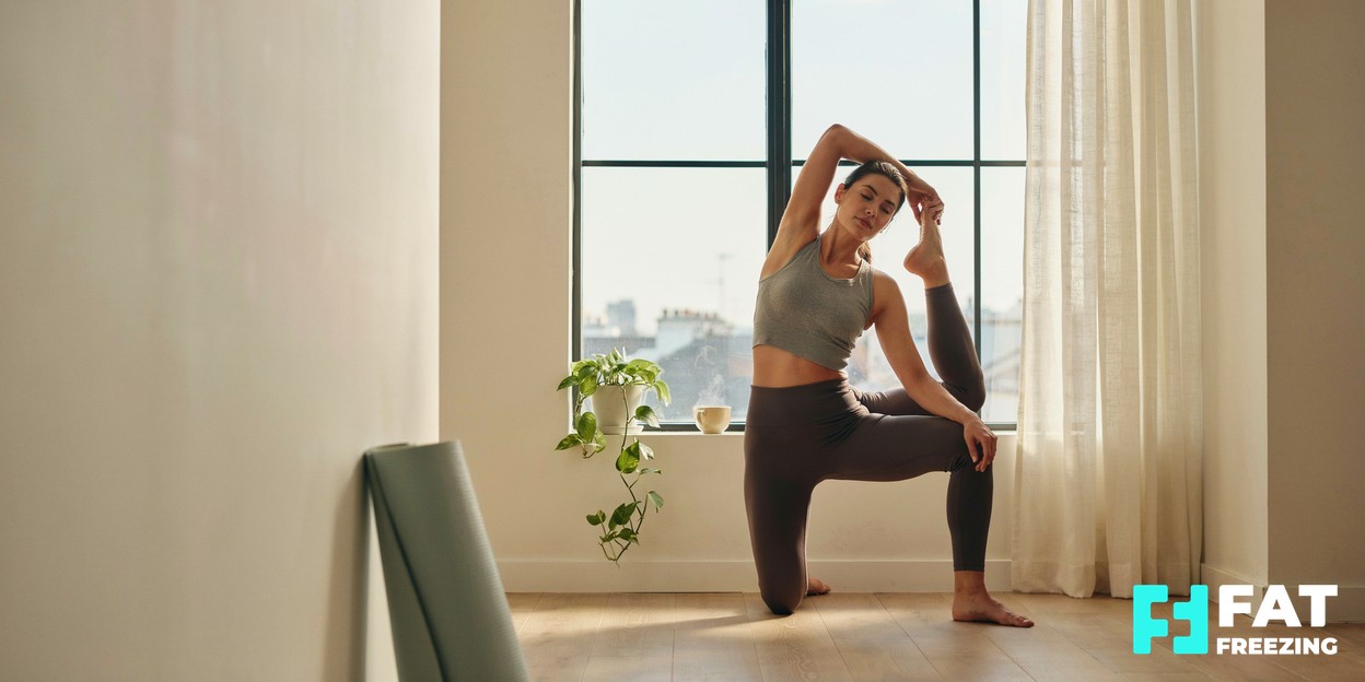 A fit, relaxed person stretching by a sunlit window in activewear, conveying strength and a healthy lifestyle